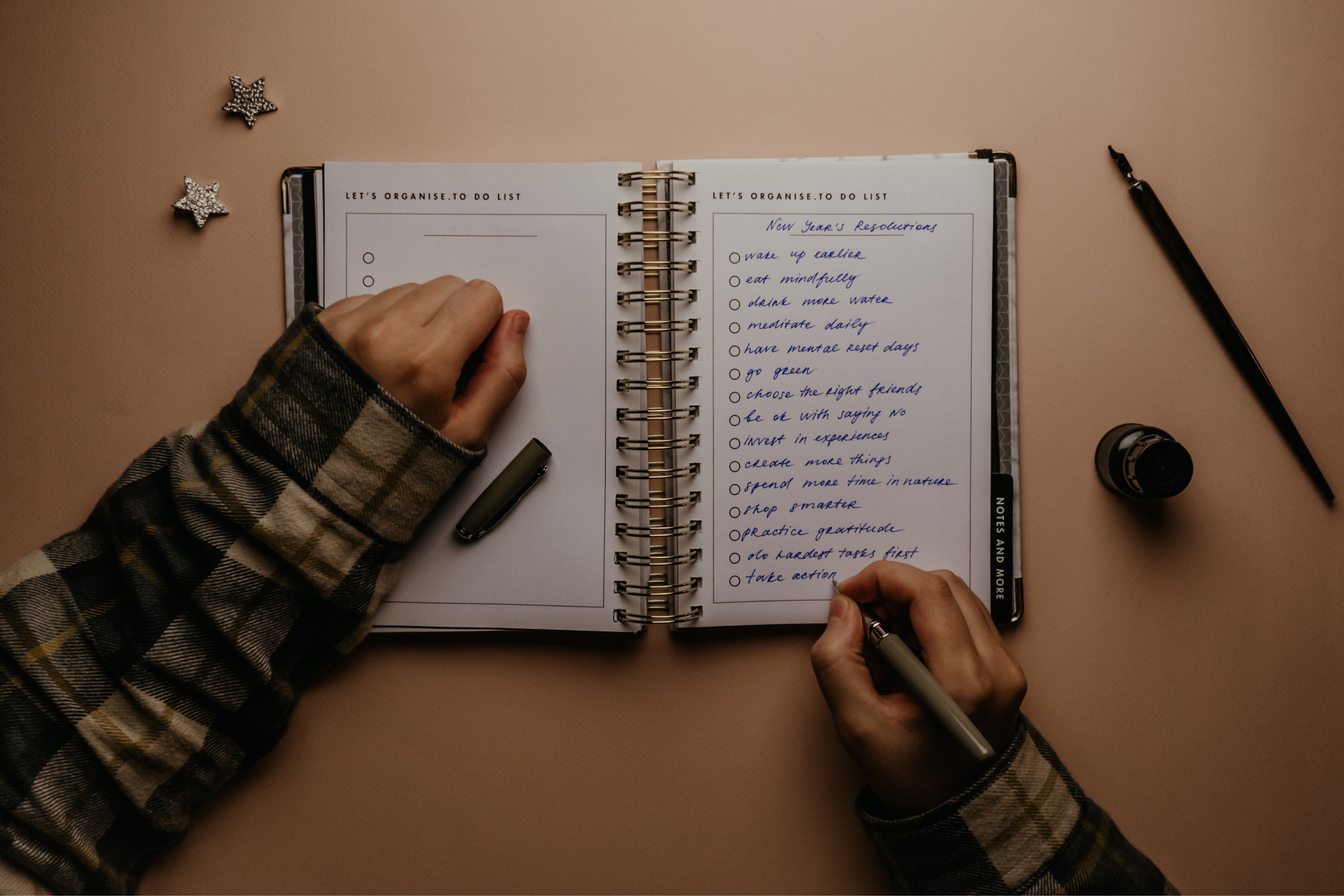 a persons hand with an open notebook