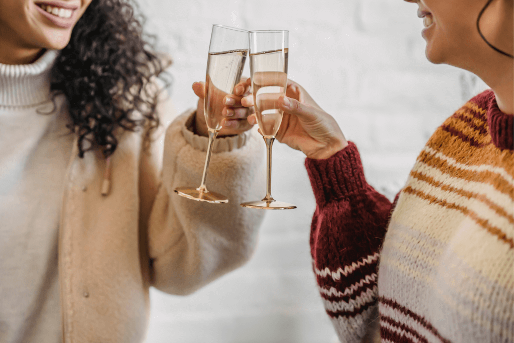 two people holding a glass of wine