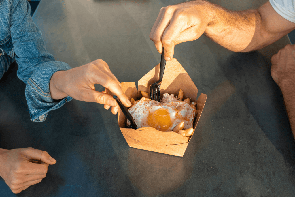 two person sharing on a take out food